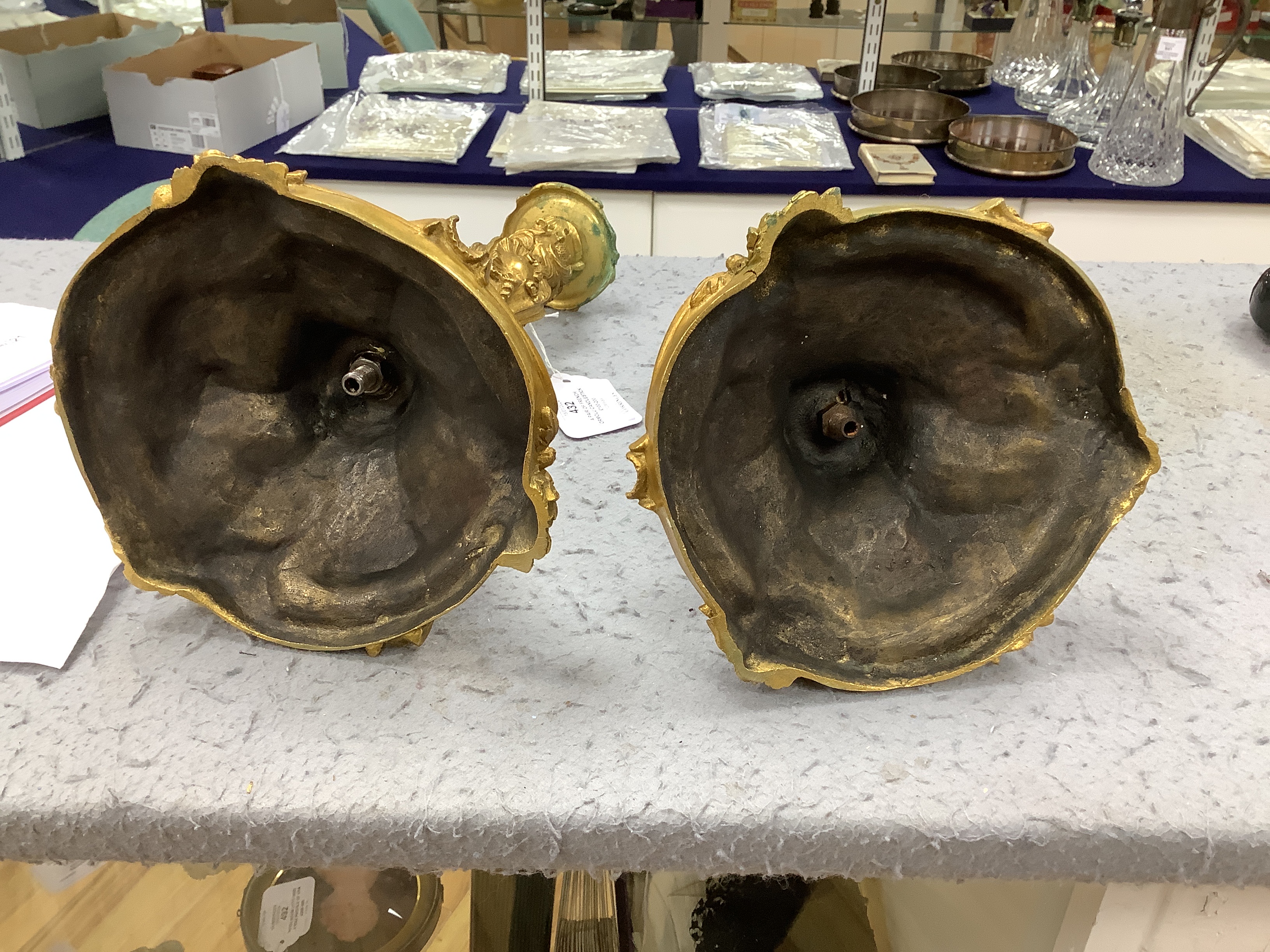 A pair of French ormolu candlesticks, one detached sconce, 30cm